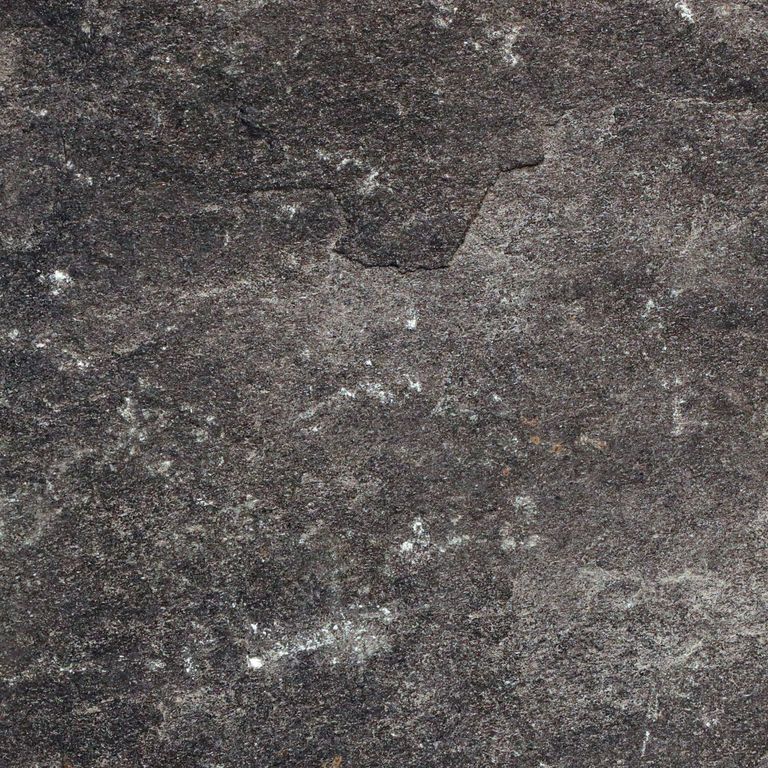Color/Finish variation image for Raven Hill Granite. The surface finish shown is split-face. Dominant colors shown are black, brown and gray. The color mix creates a cool feeling. Regular color pattern. Contains some mica and mineral inclusions.