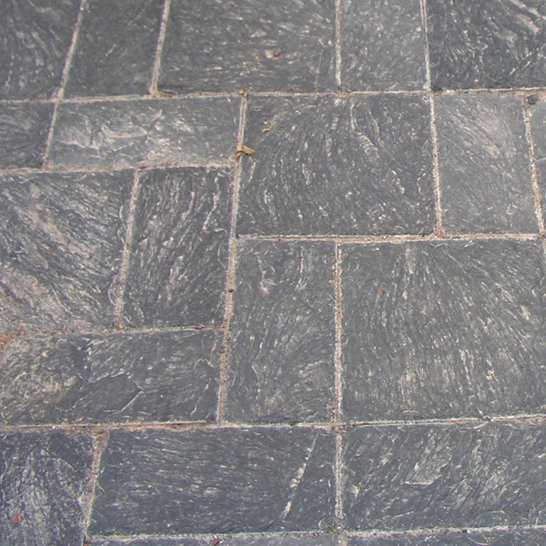 Close-up image for Vermont Slate - Black. The surface finish shown is split-face. The dominant color shown is gray; with a purple secondary. Exhibits 