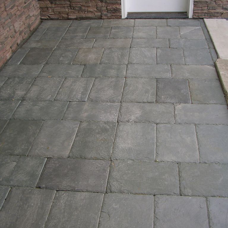 Feature image for Vermont Slate - Green. The image shows this material being used for path pavers and patio pavers. The dominant color shown is gray; with brown, green and purple secondaries. Exhibits 