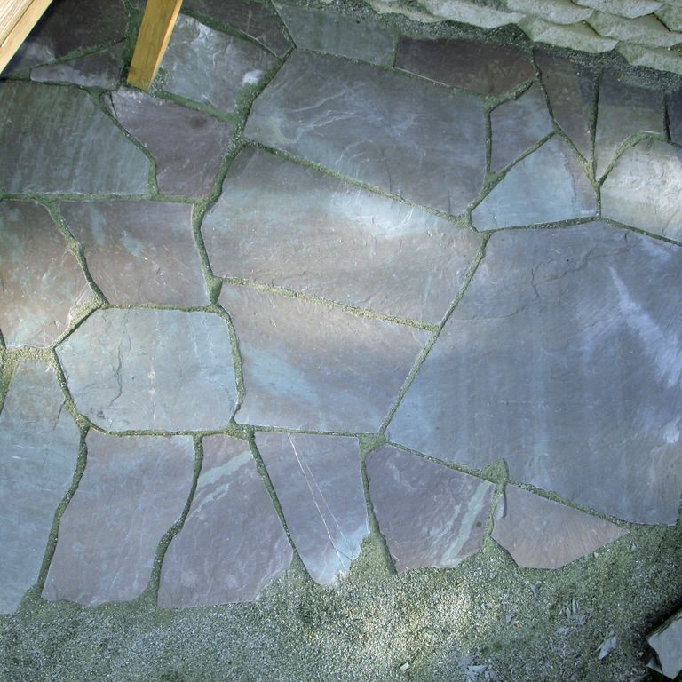 The image shows this material being used in a path pavers application.