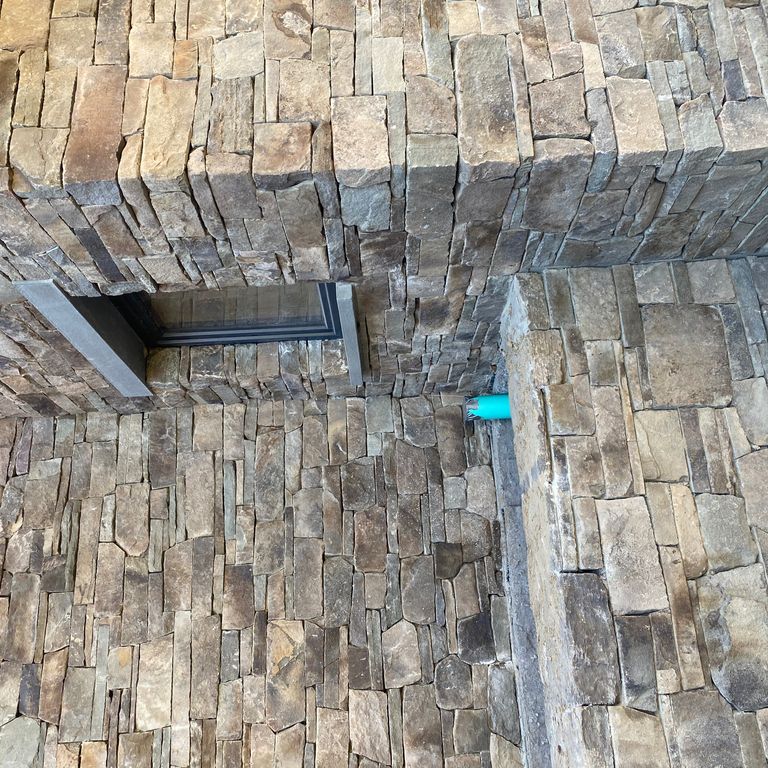 Application image for Fieldstone - Pennsylvania. The image shows this material being used in a thin veneer application. The surface finish shown is split-face. Dominant colors shown are gray and tan.