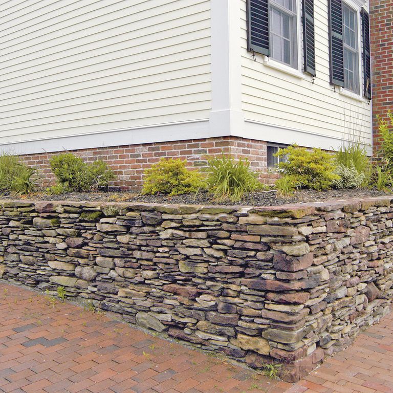 The image shows this material being used in a landscape wallstone application.