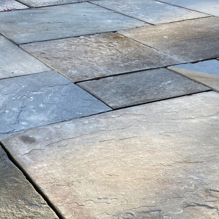 Close-up image for Reclaimed Bluestone. The surface finish shown is natural cleft. Dominant colors shown are blue, brown and gray; with beige, white, tan and cream secondaries. Exhibits 