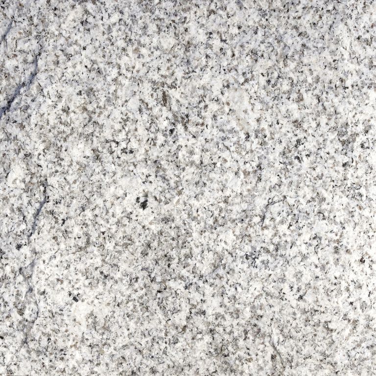 Color/Finish variation image for Iberian Gray Granite. The surface finish shown is split-face. Dominant colors shown are gray and white; with beige and cream secondaries. The color mix creates a cool feeling. Coarse speckled and cloudy color patterns.