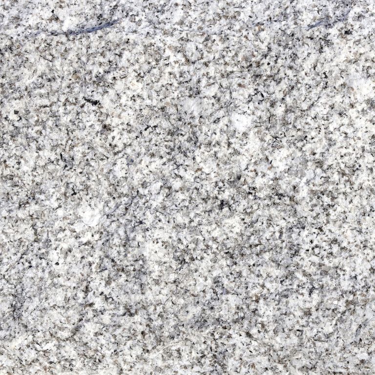 Close-up image for Iberian Gray Granite. The surface finish shown is split-face with flat plane. Dominant colors shown are gray and white. The color mix creates a cool feeling. Speckled color pattern. Contains some mica and mineral inclusions.