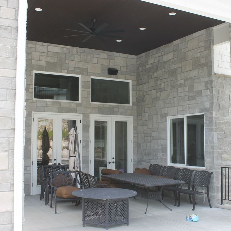 Application image for Platinum Limestone. The image shows this material being used for full bed veneer and thin veneer. The surface finish shown is split-face. The dominant color shown is gray; with a white secondary. The color mix creates a cool feeling. Regular color pattern.
