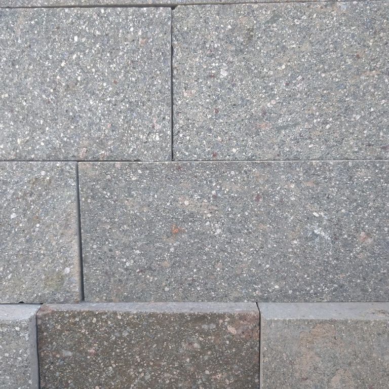 Close-up image for Porphyry Natural Surface - Gray Selected. The surface finishes shown are natural cleft and split-face. The dominant color shown is gray; with purple and white secondaries. The color mix creates a cool feeling. Speckled and fine speckled color patterns.