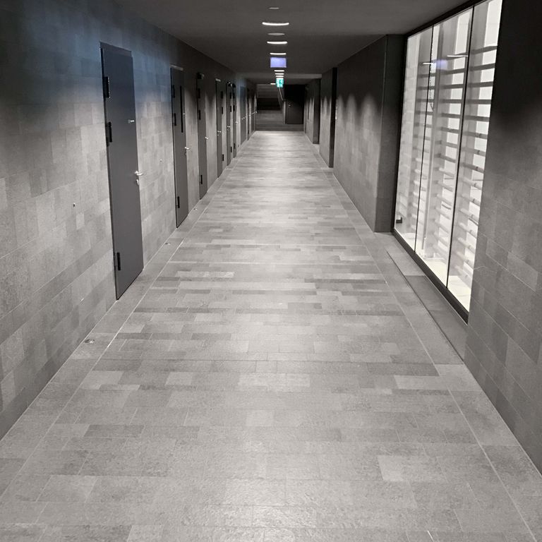 Application image for Polar Gray Limestone. The image shows this material being used in an interior floor application. The surface finish shown is leathered. The dominant color shown is gray. The color mix creates a cool feeling. Regular color pattern.