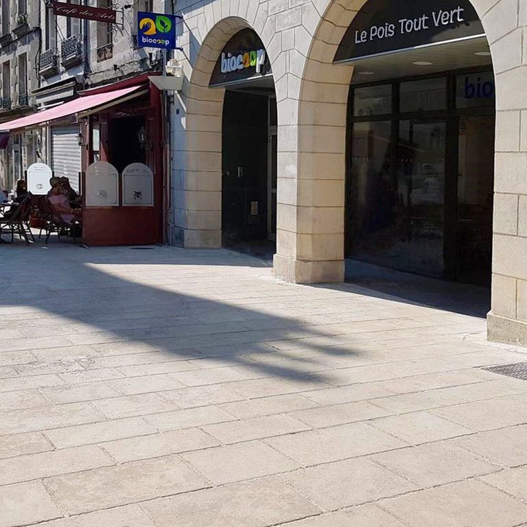 Application image for Cenia Beige Dolomitic Limestone. The image shows this material being used in a patio pavers application. The dominant color shown is beige; with a gray secondary. The color mix creates a warm feeling. Blotched color pattern.