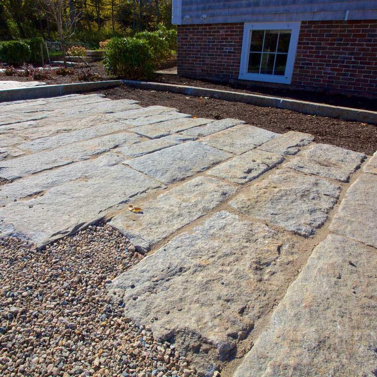 The image shows this material being used for driveway pavers, path pavers and patio pavers. The dominant color shown is gray; with beige, blue and brown secondaries. Regular color pattern.