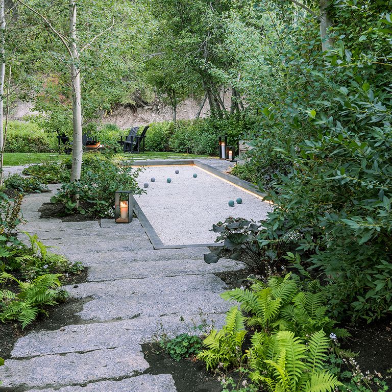 The image shows this material being used for path pavers and patio pavers. The surface finishes shown are weathered and worn. The dominant color shown is gray; with a blue secondary. The color mix creates a cool feeling. Fine speckled color pattern.