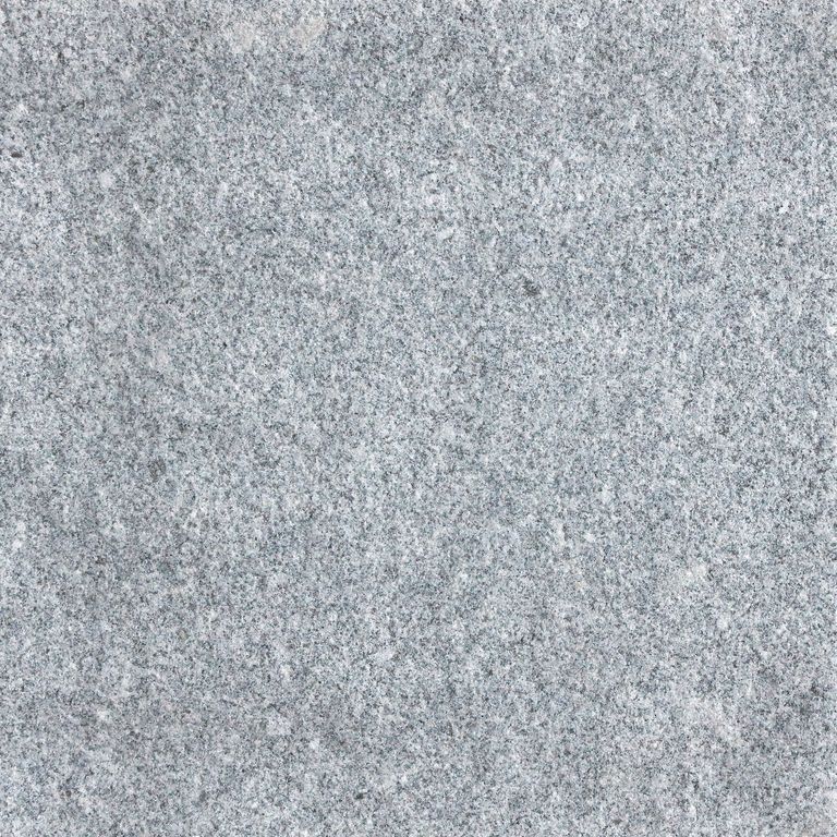 Feature image for Gray Nisa Granite. The surface finish shown is sand blasted. Dominant colors shown are blue and gray; with a white secondary. The color mix creates a cool feeling. Fine speckled color pattern. Contains some mica and mineral inclusions.