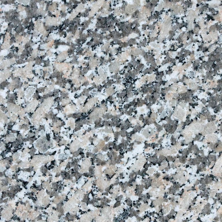 Color/Finish variation image for Lapa Gray Granite. The surface finish shown is brushed. The dominant color shown is gray. The color mix creates a cool feeling. Coarse speckled color pattern.