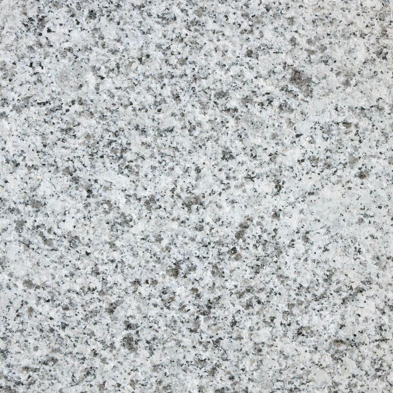 Feature image for Gray Salis Granite. The surface finish shown is flamed. Dominant colors shown are gray and white; with beige, black, blue, pink and cream secondaries. The color mix creates a cool feeling. Speckled color pattern. Contains some mica and mineral inclusions.