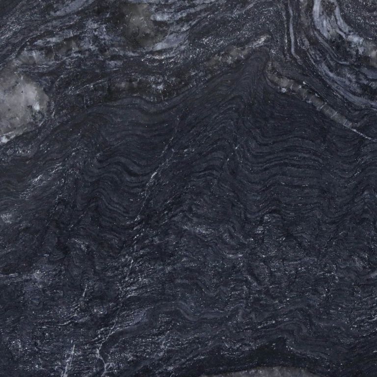 Feature image for Cloudy Night Granite. The dominant color shown is black; with blue, brown, gray and purple secondaries. Exhibits 
