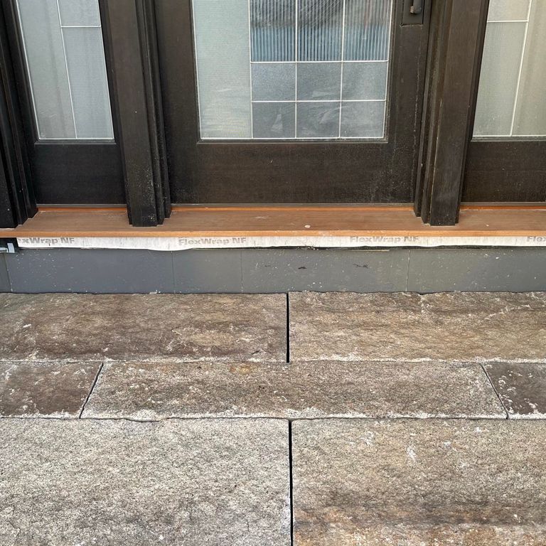 The image shows this material being used in a monolithic steps application. The dominant color shown is gray; with beige, brown, orange/rust, white, tan and cream secondaries. The color mix creates a warm feeling. Regular color pattern.