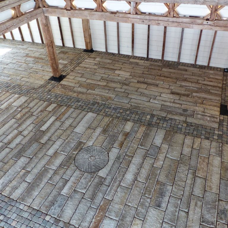 The image shows this material being used for interior floor and driveway pavers.