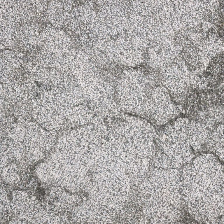 Best close-up image for Blue Noble Limestone. The surface finish shown is bush hammered. The dominant color shown is gray; with beige, blue, pink, purple, white, tan and cream secondaries. Exhibits 