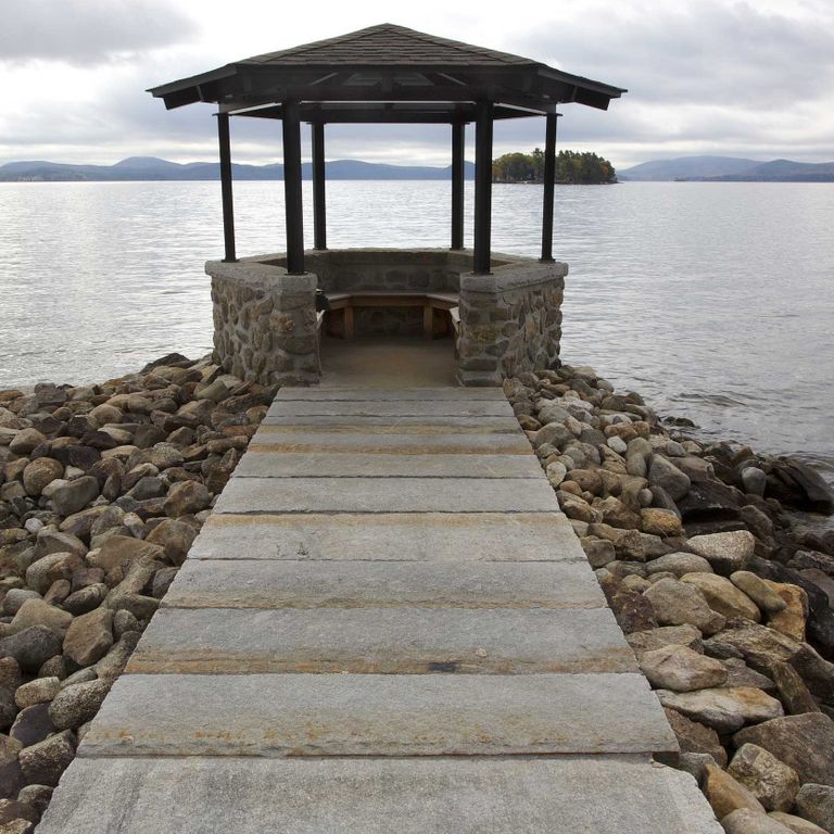 The image shows this material being used for path pavers and patio pavers. The dominant color shown is gray; with brown and orange/rust secondaries. Regular color pattern.