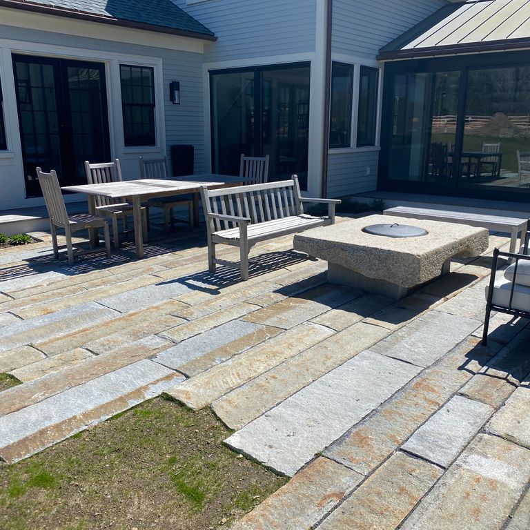The image shows this material being used in a patio pavers application. The dominant color shown is gray; with beige, blue, brown, orange/rust, white and cream secondaries. The color mix creates a warm feeling. Regular color pattern.