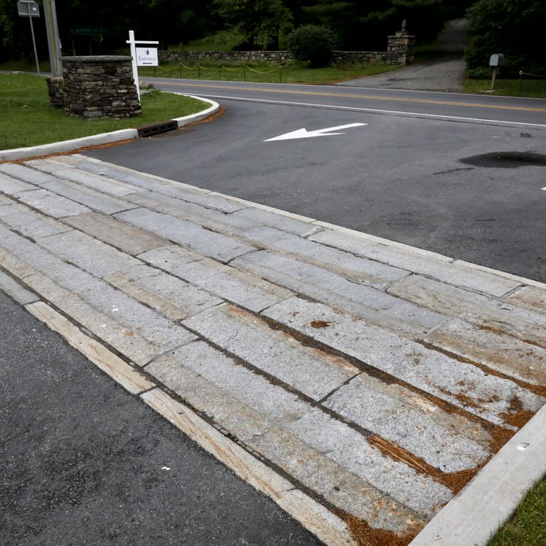 Application image for Granite - Reclaimed Third Generation Curbstone. The image shows this material being used in a driveway aprons application.