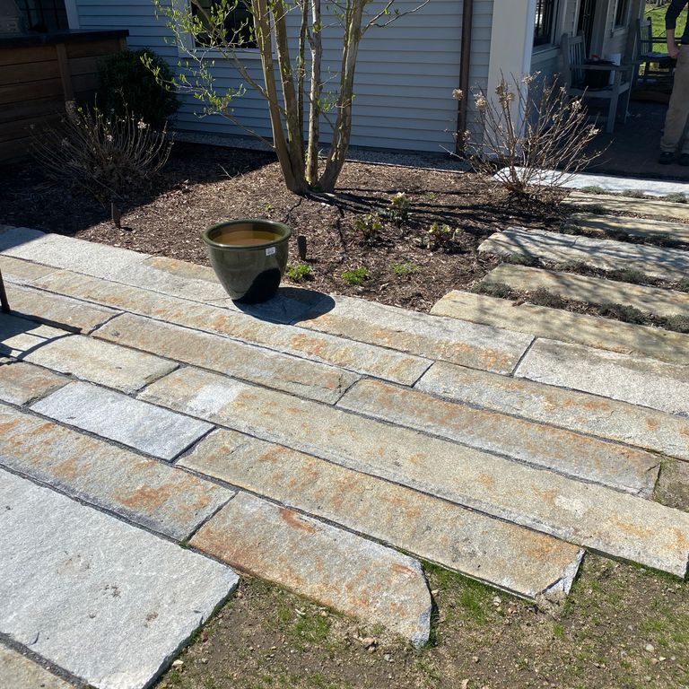 The image shows this material being used in a patio pavers application. Dominant colors shown are beige and gray; with blue, brown and orange/rust secondaries. The color mix creates a warm feeling. Regular color pattern.