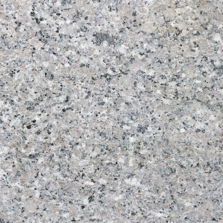 Best close-up image for Kershaw Pink Granite. The surface finish shown is honed. Dominant colors shown are beige, gray and white; with purple and cream secondaries. The color mix creates a cool feeling. Coarse speckled color pattern. Contains some mica and mineral inclusions.