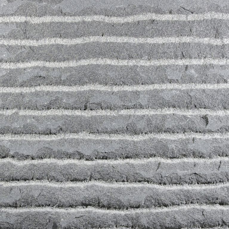 Color/Finish variation image for Sugus Bluestone. The surface finish shown is point stalk. The dominant color shown is gray; with a white secondary. The color mix creates a cool feeling. Fine speckled and linear color patterns.