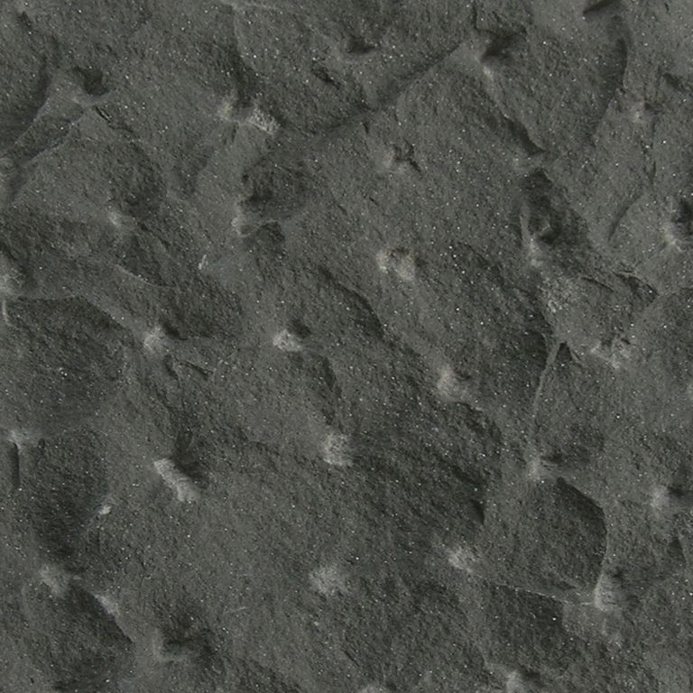 Color/Finish variation image for Sugus Black Sandstone. The surface finish shown is pineapple. Dominant colors shown are black and gray. The color mix creates a cool feeling. Blotched and random color patterns.