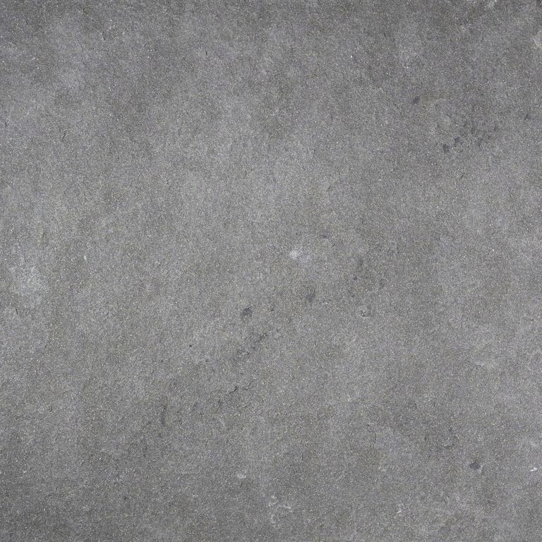 Close-up image for Sugus Black Sandstone. The surface finish shown is flamed. The dominant color shown is gray; with green and purple secondaries. The color mix creates a cool feeling. Regular color pattern.