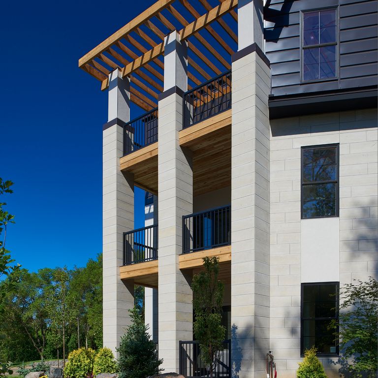 Application image for Midwest Gray Limestone. The image shows this material being used for full bed veneer and thin veneer. The surface finish shown is sand blasted. Dominant colors shown are blue and gray; with beige and cream secondaries. The color mix creates a warm feeling. Regular color pattern.