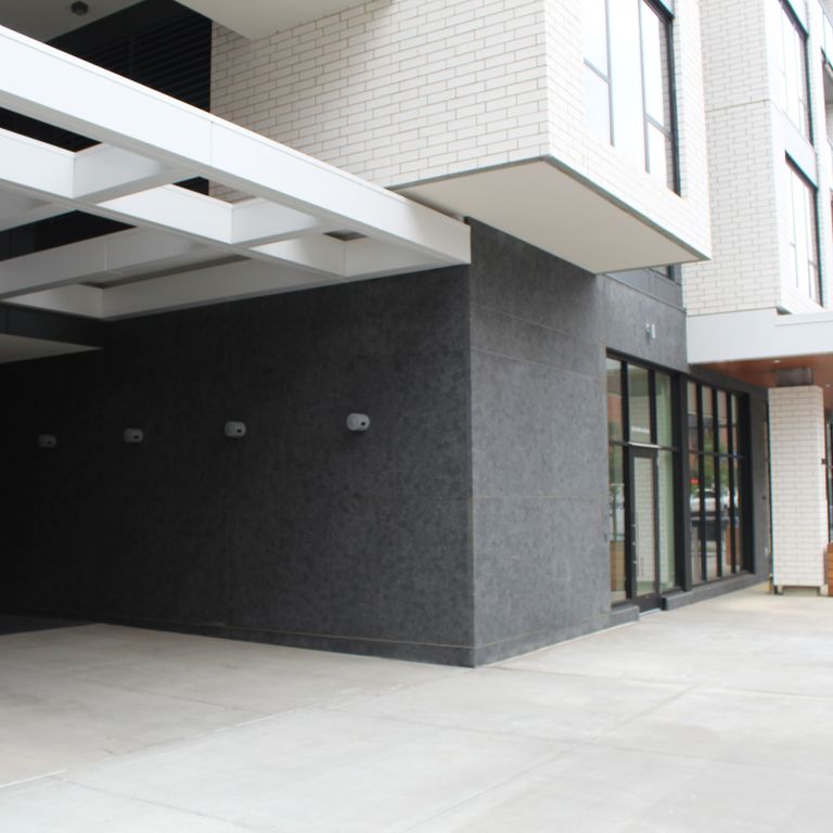 Application image for Midwest Superior Northern Granite. The image shows this material being used for full bed veneer and thin veneer. The surface finish shown is leathered. Dominant colors shown are blue and gray. The color mix creates a cool feeling. Solid color pattern.