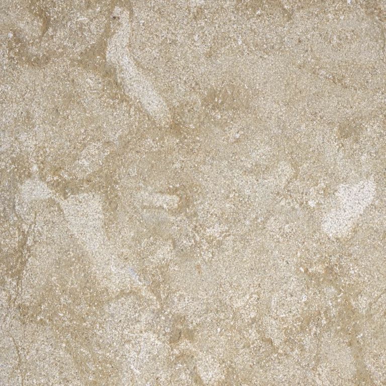 Feature image for Giallo Medici Limestone. The surface finish shown is fine bush hammered. Dominant colors shown are beige and tan; with brown, gray, orange/rust and cream secondaries. The color mix creates a warm feeling. Random color pattern. Contains mineral inclusions.