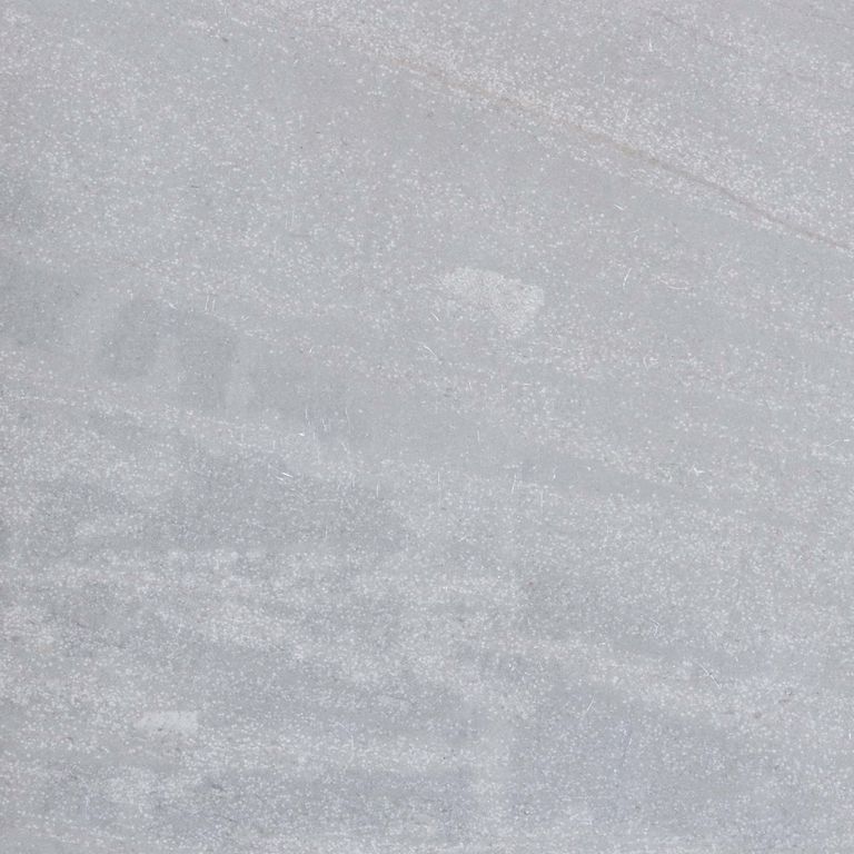 Feature image for Pacific Gray Limestone. The surface finish shown is honed. The dominant color shown is gray; with beige, blue and white secondaries. Exhibits 