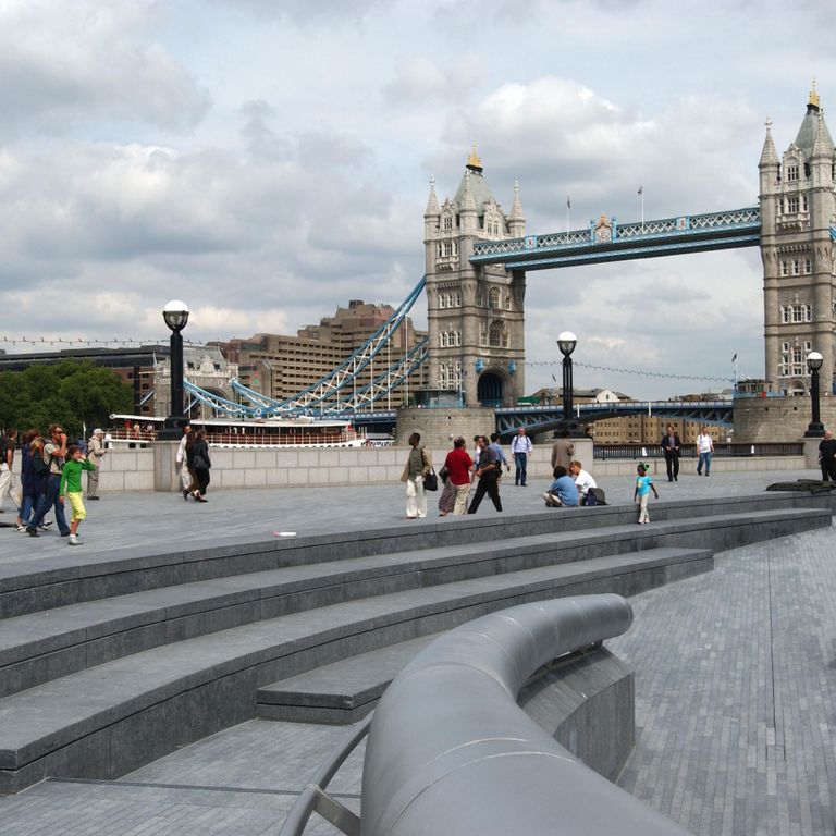 Application image for Kilkenny Limestone. The image shows this material being used for architectural elements, seating & benches, patio pavers and treads. The surface finish shown is flamed. The dominant color shown is gray; with a blue secondary. The color mix creates a cool feeling. Regular color pattern.