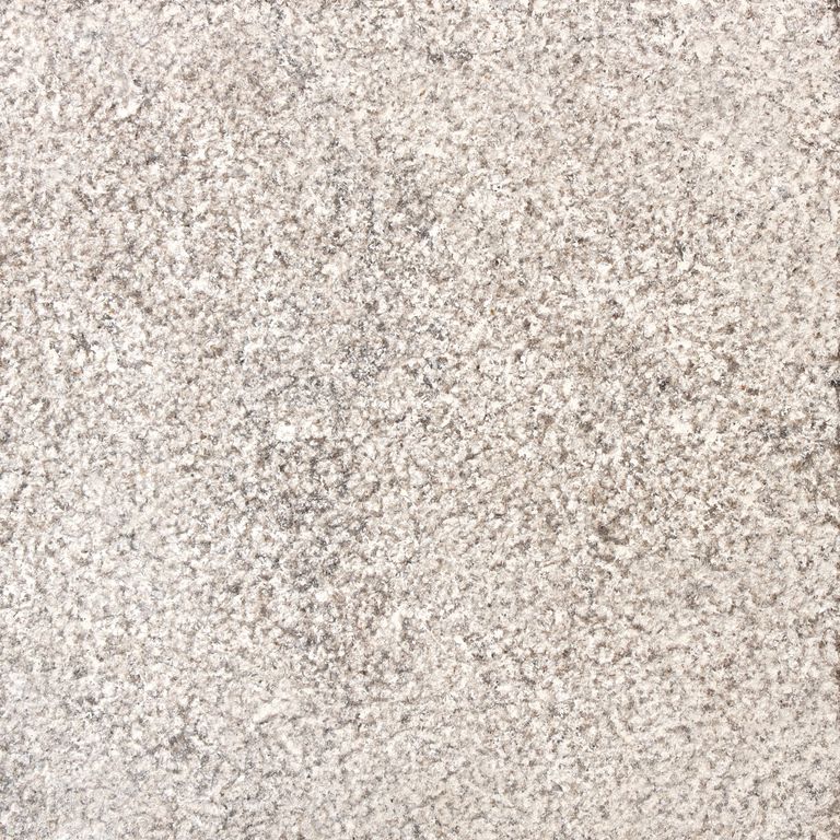The surface finish shown is bush hammered. Dominant colors shown are beige, gray, white and cream. The color mix creates a warm feeling. Speckled and blotched color patterns.