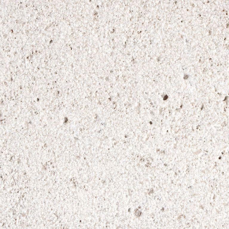 Best close-up image for Bianco Dei Travertine. The surface finish shown is sand blasted. Dominant colors shown are beige, white, tan and cream; with a gray secondary. The color mix creates a warm feeling. Regular color pattern. Contains voids.