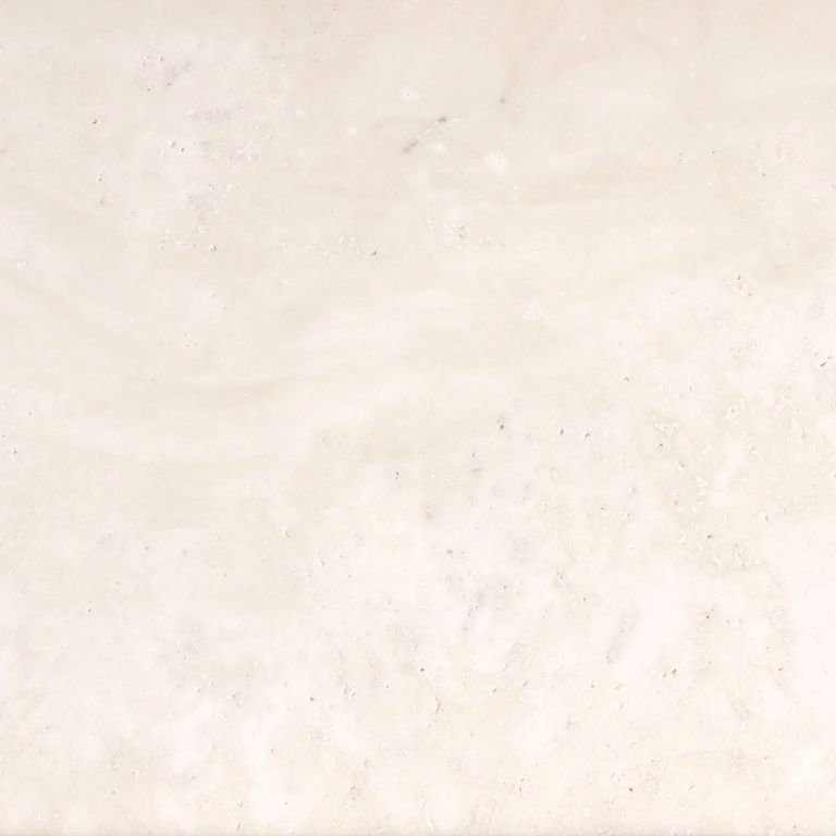 Feature image for Bianco Dei Travertine. The surface finish shown is honed. Dominant colors shown are beige, white and cream. The color mix creates a warm feeling. Solid and cloudy color patterns. Contains voids.
