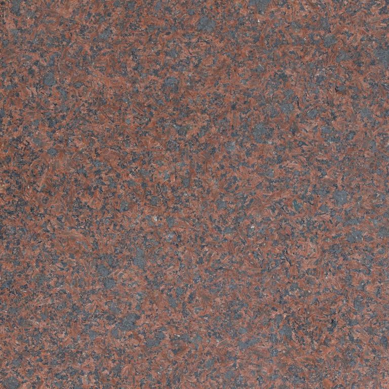 Feature image for Granite - Princess Red. The surface finish shown is honed. The dominant color shown is red; with green, gray, orange/rust, purple and tan secondaries. The color mix creates a warm feeling. Speckled color pattern. Contains some mica and mineral inclusions.