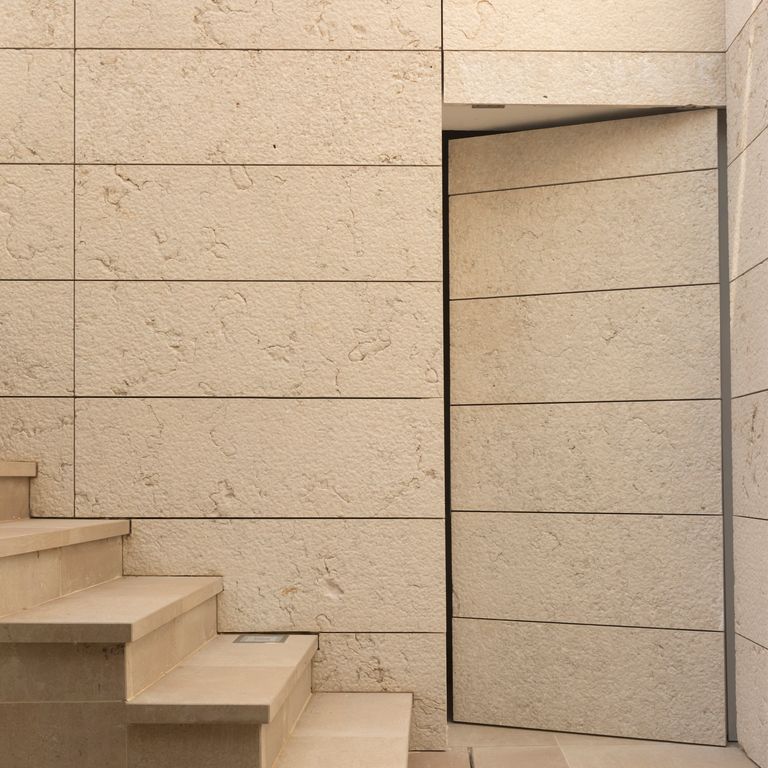 Application image for Veneto Beige Limestone - Veneer. The image shows this product being used in an interior cladding application. The surface finish shown is . Dominant colors shown are beige and tan. The color mix creates a warm feeling.