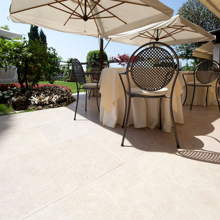 Application image for Veneto Beige Limestone - Pavers. The image shows this product being used in a patio pavers application. The surface finish shown is . Dominant colors shown are beige and cream. The color mix creates a warm feeling.