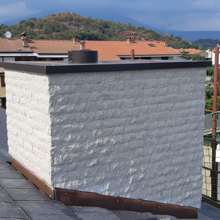 Application image for Veneto Olivo Limestone - Veneer. The image shows this product being used in a thin veneer application. The surface finish shown is split-face. The dominant color shown is gray. The color mix creates a cool feeling.