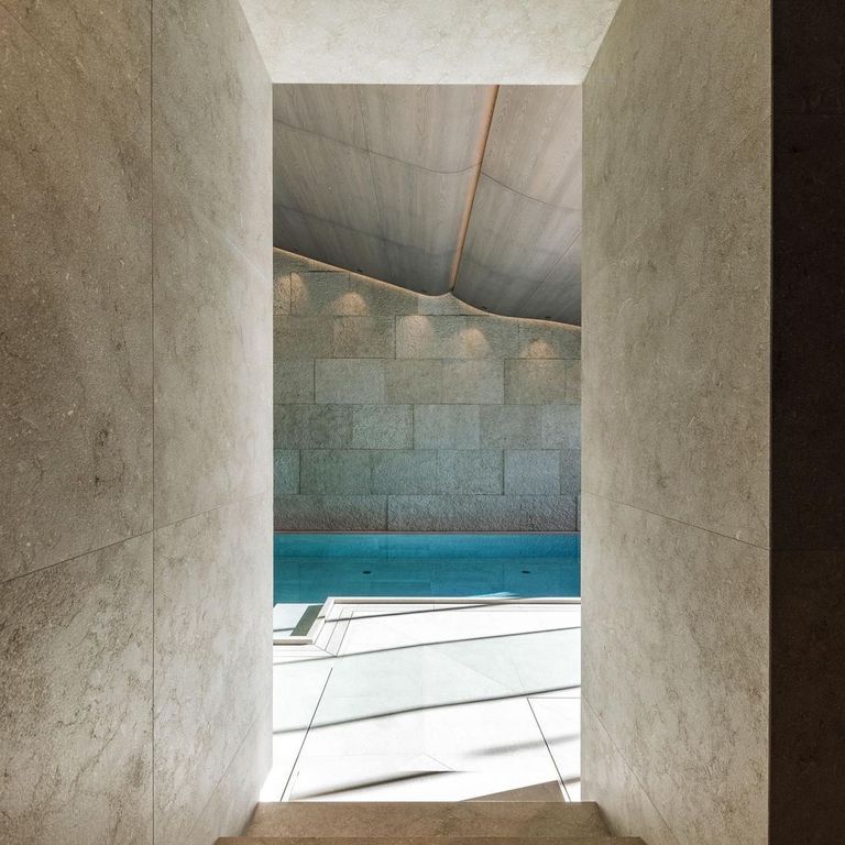 Application image for Veneto Olivo Limestone - Veneer. The image shows this product being used in a full bed veneer application. The surface finish shown is flamed. Dominant colors shown are gray and tan. The color mix creates a warm feeling.