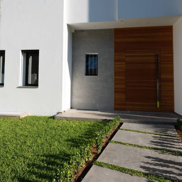 Feature image for Casablanca Limestone - Pavers. The image shows this product being used in a path pavers application. The surface finish shown is flamed. The dominant color shown is gray. The color mix creates a warm feeling.