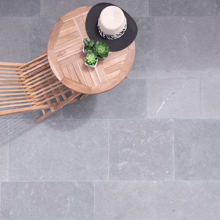 Application image for Casablanca Limestone - Pavers. The image shows this product being used in a patio pavers application. The surface finish shown is antiqued. The dominant color shown is gray. The color mix creates a warm feeling.