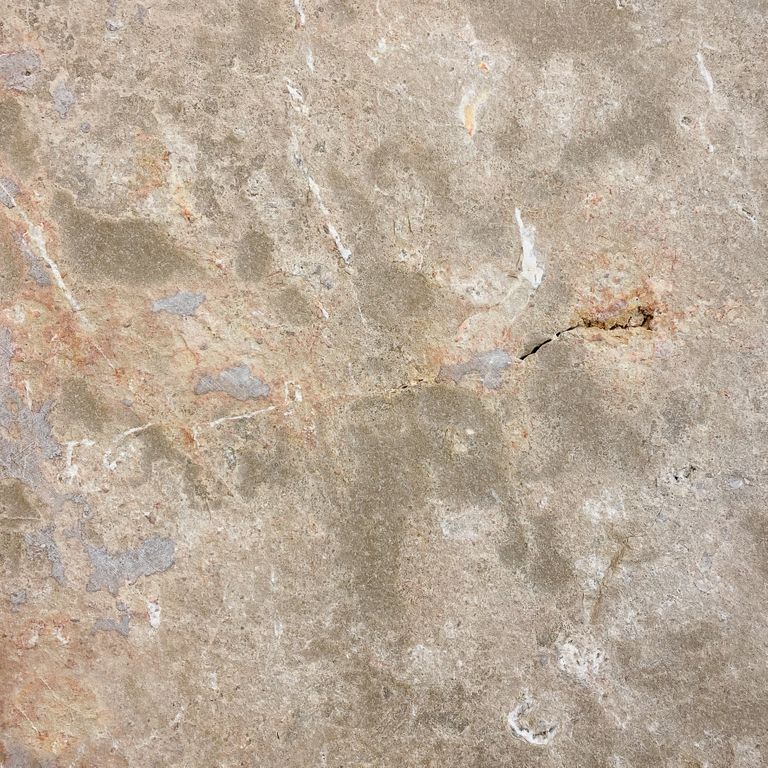 Color/Finish variation image for Bavarian Dolomite Gray Limestone - Irregular Pavers - Waterjet Cut Edge. The surface finish shown is flamed. The dominant color shown is tan; with beige, blue, brown, gray, orange/rust and cream secondaries. Exhibits 