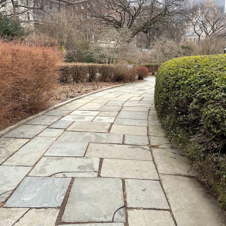 Application image for Reclaimed Bluestone Hand Cut Pavers. The image shows this product being used for path pavers and public area. The surface finish shown is natural cleft. The dominant color shown is gray. The color mix creates a warm feeling.