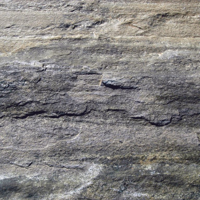 Swatch image cropped for Granite- Mystic Mountain- Natural - Oversized Pavers. The surface finishes shown are natural, split-face and split-face with rough plane. The dominant color shown is gray; with beige, blue, brown, green, orange/rust, purple, white and tan secondaries. Exhibits 