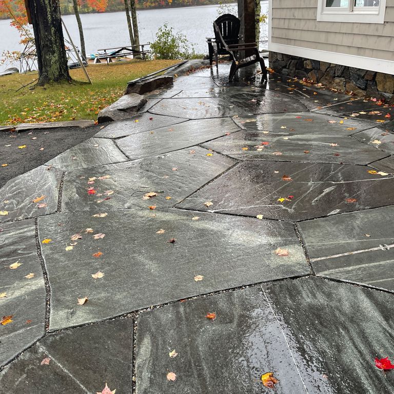 Application image for Mystic Mountain Cut to Fit Pavers. The image shows this product being used in a patio pavers application. The surface finish shown is flamed. Dominant colors shown are green and gray; with brown and white secondaries. Streaked color pattern.