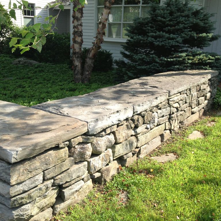 Application image for Mystic Mountain Natural - Wallstone. The image shows this product being used in a landscape wallstone application.